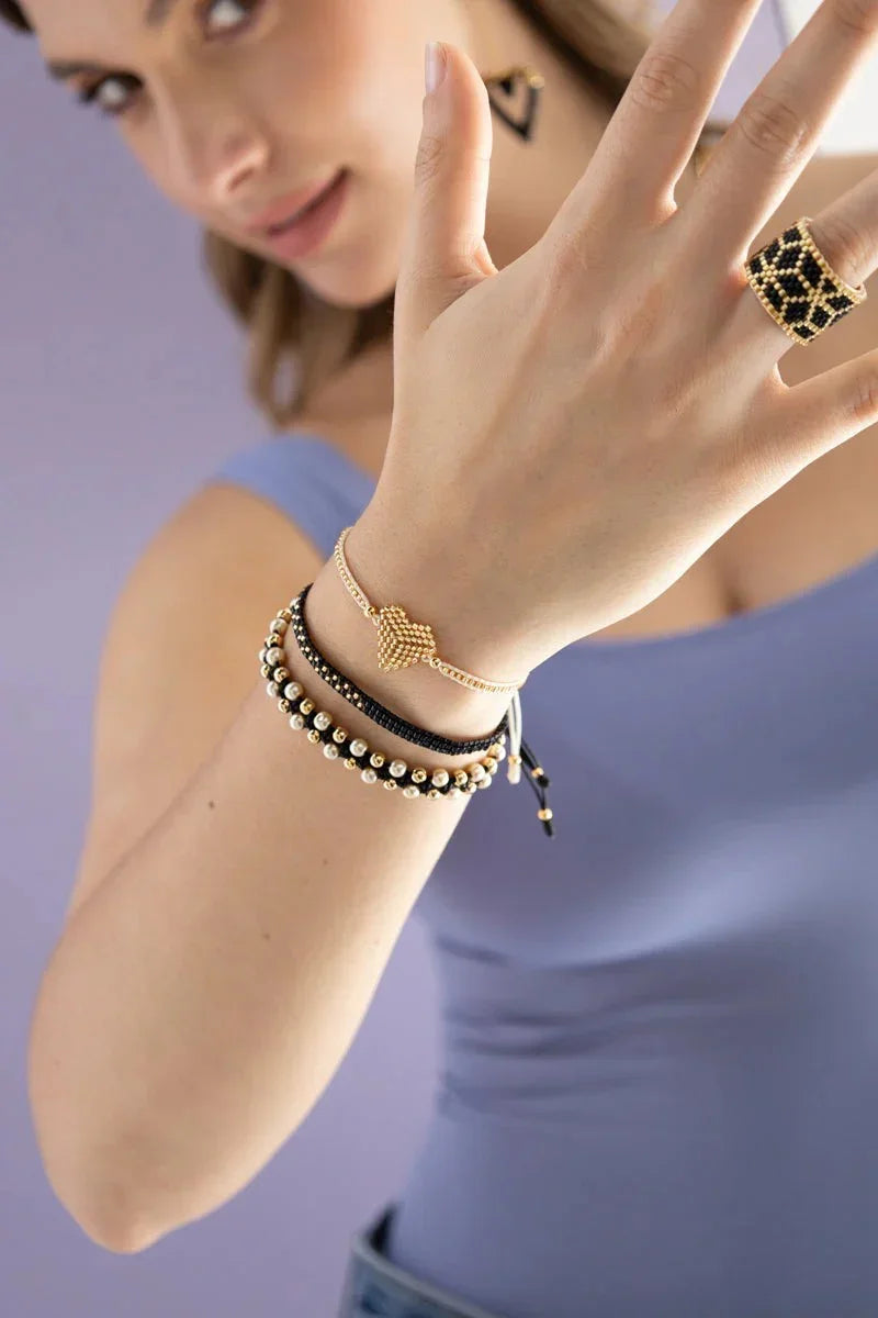 Woman wearing handmade beaded bracelets and a statement ring by Jabatzelet jewelry