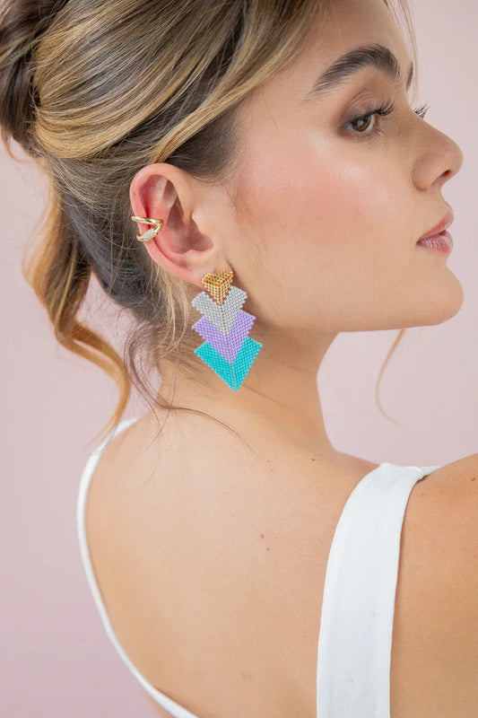 Handmade Jabatzelet beaded statement earrings in pastel colors worn by woman