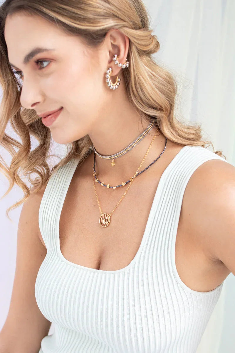 Woman wearing layered handmade jewelry chokers and gold necklaces from Jabatzelet