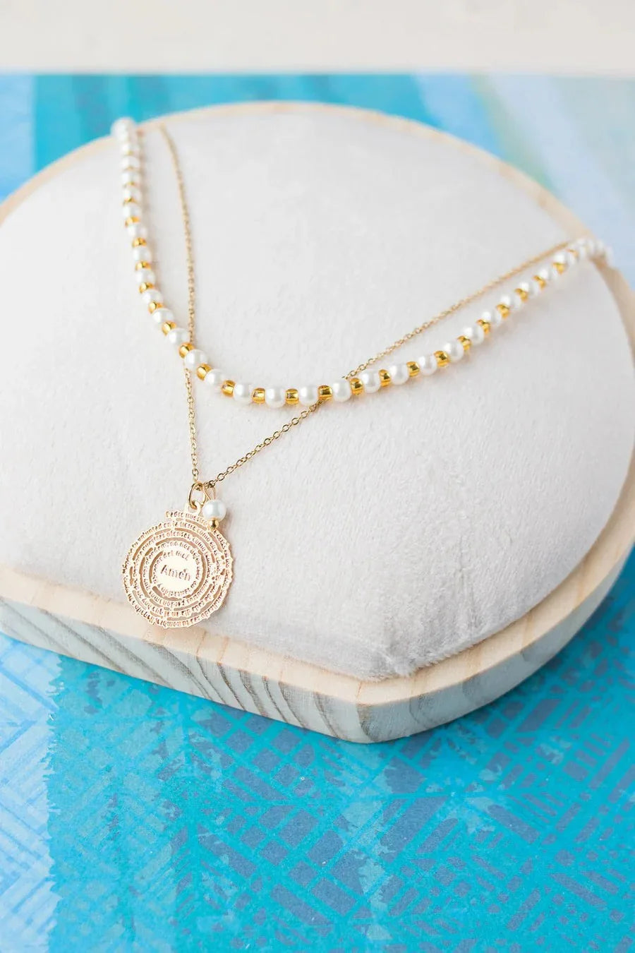 Handmade gold and pearl necklace with medallion pendant on display, Jabatzelet jewelry.